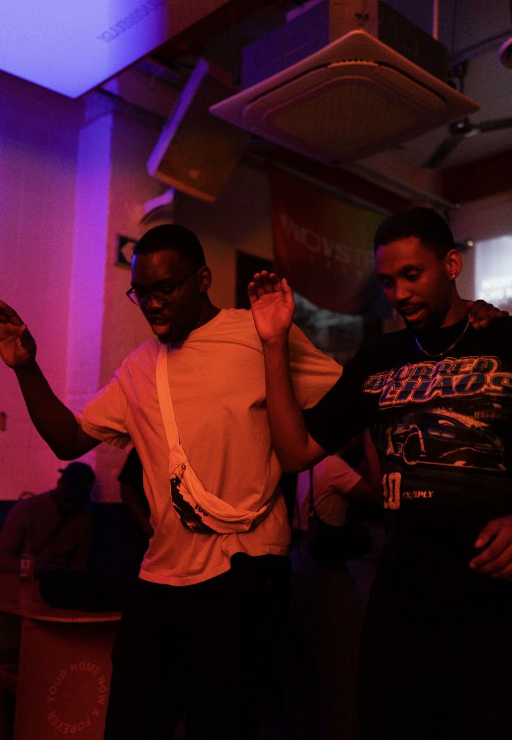 Guests dancing under warm lights at an Indvstry Exchange after-party