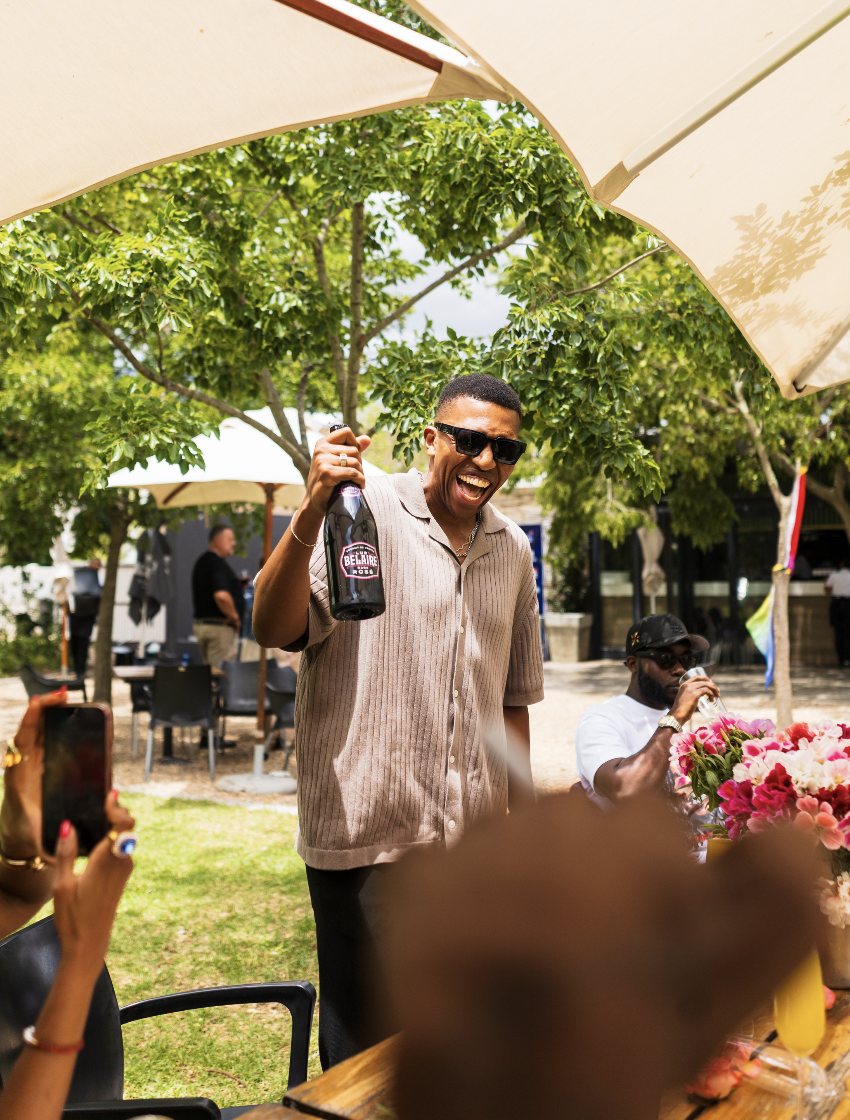 Guest celebrating with a bottle of Belaire at the Indvstry Exchange gathering
